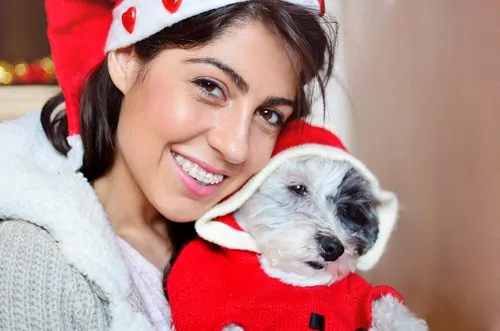 woman smiling holding dog