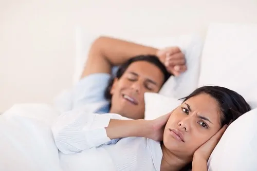 man snoring woman grimacing