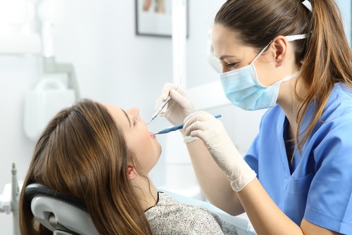 hygienist performs cleaning