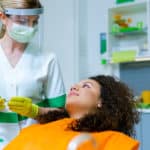 dentist in ppe with patient