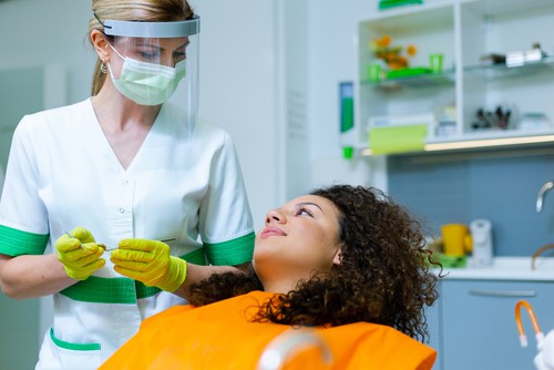 dentist in ppe with patient